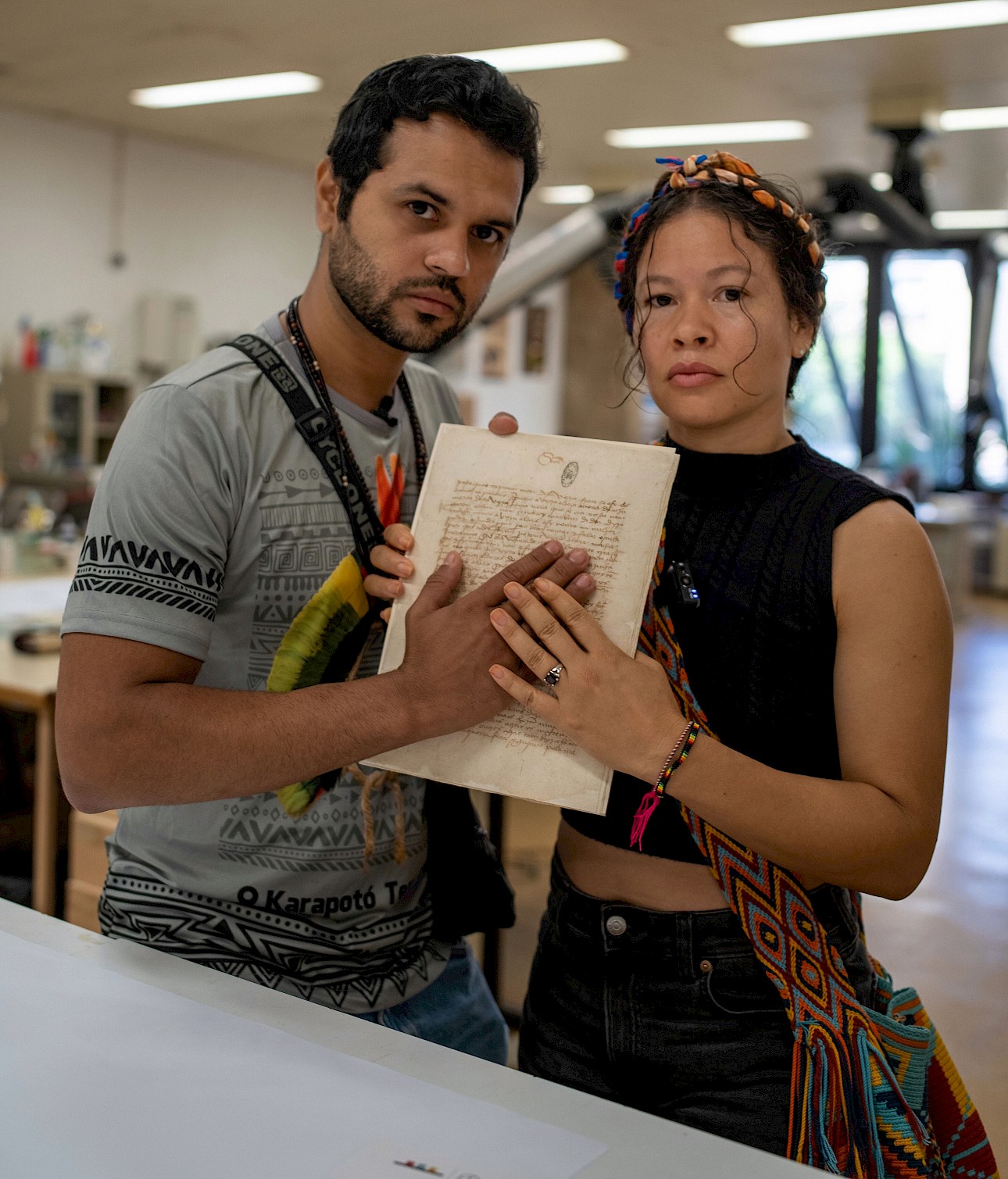 ALKANARA - Olinda Tupinambá and Ziel Karapotó, the first Indigenous and Northeastern people to handle the Letter of Pero Vaz de Caminha, 525 years after it was written. National Archives of Torre do Tombo, May 2025. - ©Ritó Natálio. Olinda Tupinambá and Ziel Karapotó, the first Indigenous and Northeastern people to handle the Letter of Pero Vaz de Caminha, 525 years after it was written. National Archives of Torre do Tombo, May 2025.
